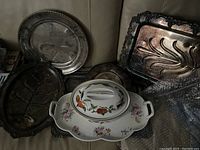 Lot of various serving trays including brass, metal, and porcelain items with floral and fruit decoration and patina