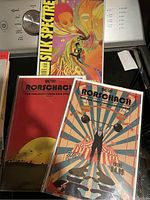 Photo of three Watchmen comic books: two Rorschach comics and one Silk Spectre comic.