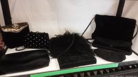 Eight evening bags arranged on a white background showing variety in textures and designs.