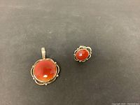 Top view of the matching orange stone pendant and ring set in silver.