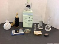 Group view of all perfume bottles and vintage compacts on display surface