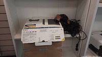 Sony PlayStation 2 box with console partially visible inside.