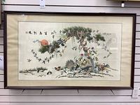 Full view of framed silk embroidery depicting birds, tree branches and sun