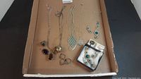Tray of assorted sterling silver jewelry with pendants, necklaces, earrings, rings