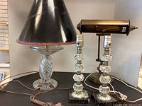 Group photo of crystal lead table lamp, brass desk lamp, and two matching glass lamps together