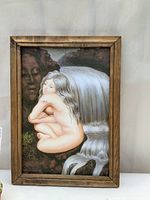 Framed optical illusion art print visible clearly showing the young woman and elderly woman illusion with waterfall background.