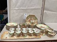 Image showing full coffee and dessert set with cups, plates, serving bowls, and tray displayed on a table