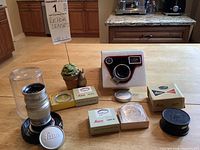 Overview of all lot contents on table including lenses, boxes, cases and accessories