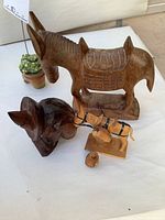 Wooden carved donkey figure with saddle, dark brown carved dog toothpick holder, small painted wooden donkey with barrels, small wooden container with lid