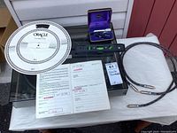 Overview of turntable with cover, calibrator, level, cable and paperwork