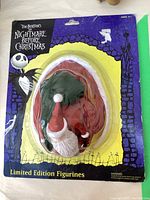 Front view of sealed Nightmare Before Christmas Santa figurine on original packaging showing branding and figurine details.