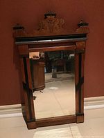 Front view of the Eastlake style hand-painted wooden framed antique mirror with decorative top and aged glass.