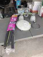 Full view of all items on the table including vanity light, towel ring, pipe insulation, and flush mount light.