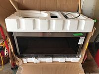 Microwave in original cardboard box with styrofoam inserts