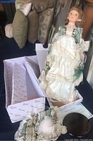 Full body of porcelain doll in period dress with certificate and box