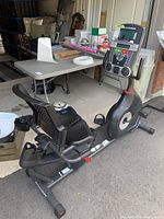 Side view of Schwinn recumbent exercise bike showing seat, pedals, frame, and console