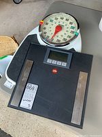Top view of two scales showing Life brand digital scale on top and Metro vintage style mechanical scale underneath.