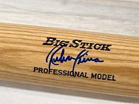 Close-up of the signed baseball bat showing Rubin Sierra's autograph and 'Big Stick Professional Model' branding.