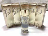 Five original boxed bottles of Cle De Peau Beaute Hydro-Clarifying Lotion and one loose bottle.