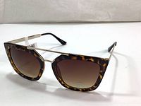 Side view of Joe Fresh sunglasses showing tortoiseshell frames, gold-tone metal bridge and temples, gradient brown lenses.