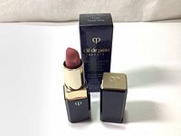 Opened lipstick showing the 102 Sweet Song shade with matching box in background