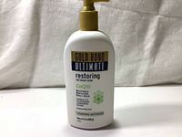 Front view of a Gold Bond Ultimate Restoring Skin Therapy Lotion bottle with pump, showing product branding and details.