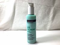 Full view of light turquoise bottle with white pump top and Neutrogena Skin Balancing label for oily skin cleanser.