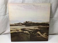 Front cover of The Moody Blues Seventh Sojourn album showing desert landscape with band name and album title.