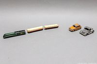 Photo showing entire lot of 6 die-cast toy items including three train pieces and two cars.