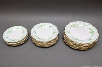 Full view of all plates stacked in three separate piles by size: six 6.5-inch, six 8.5-inch, and eight 10-inch plates, showing the set quantity and size variations.