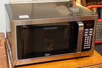 Front view of the stainless steel Master Chef microwave showing the door and handle.