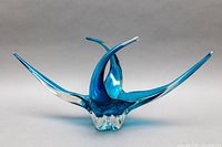 Front view showing five pointed flared arms and curved central basin