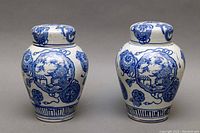Front facing view of the pair of blue and white Chinese ginger jars showing their shape and decoration.