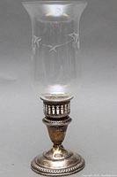 Full view of antique sterling silver hurricane lamp with etched glass shade showing overall condition and design detail.