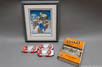 Full lot arranged with framed print, sealed stamp sets, and hockey book displayed on a table.