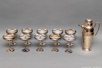 Set of 10 silver plated champagne glasses and one silver plated coffee carafe with pressure lid shown together