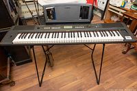 Full view of keyboard mounted on X-style stand with music rest