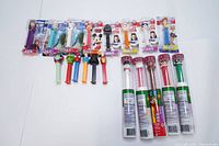 Photo showing all 19 PEZ dispensers including sealed and loose. Characters include Frozen, Star Wars, and Christmas themes.