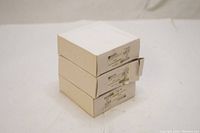 Three unopened white cardboard boxes stacked, each labeled with Brady branding and lockout hasp model information.