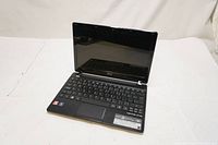 Front view of Acer Aspire ONE 725-0691 with screen open and keyboard visible.