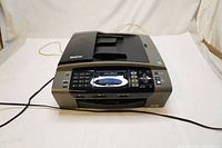 Front view of the Brother MFC-495CW multifunction colour inkjet printer showing top auto document feeder, control panel and power cord.