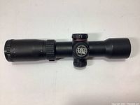 Side view of black Excalibur Tact Zone scope showing adjustment knobs and matte finish.