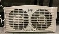 Front view of Hampton Bay twin fan window fan showing dual 9-inch fans and control knobs on the front panel.