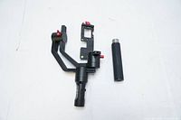 Hohem DSLR gimbal stabilizer frame and detachable handle placed on white surface, showing side angle.