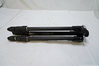 Folded tripod showing compact size and carbon fiber legs with twist locks.