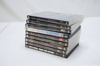 Stack of 9 DVD cases aligned horizontally showing spines with X-Files seasons and movie titles.