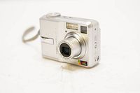 Front view of Kodak EasyShare C643 digital camera in silver with lens extended and strap attached.