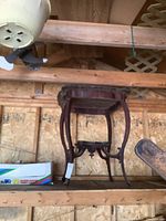 Wooden fern stand shown on a wooden shelf with a box and other workshop items nearby, highlights entire item upright.