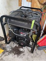 Full view of the generator showing frame, fuel tank, and power cord on top.