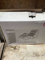 Box with image of zero gravity chair and brand Cosmopolitan on front.